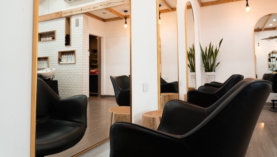 Stylish salon interior at Linea Of The Yarra Valley, Lilydale, Victoria, AU with black chairs and mirrors.
