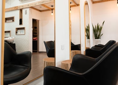 Stylish salon interior at Linea Of The Yarra Valley, Lilydale, Victoria, AU with black chairs and mirrors.