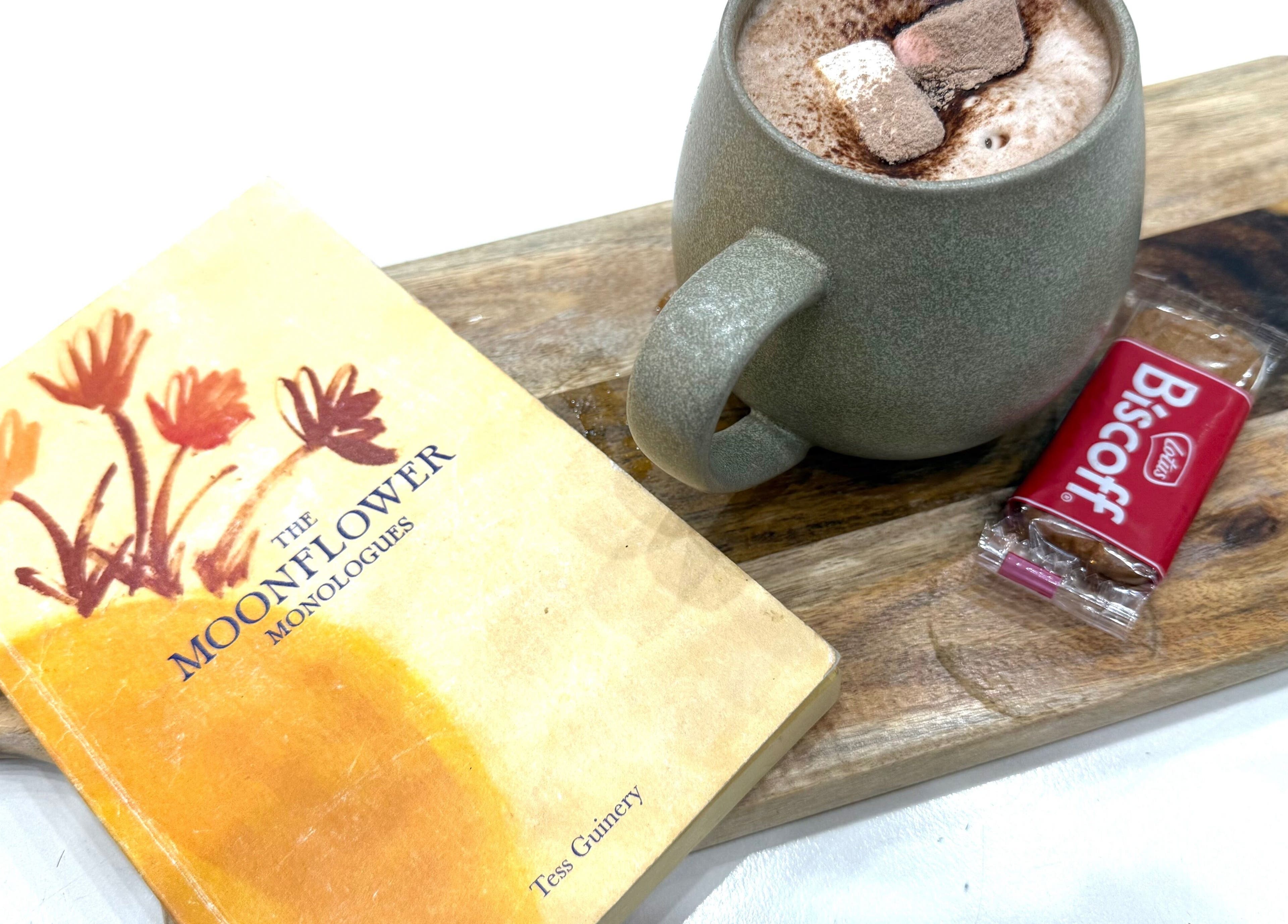 Warm drink, book, and biscuit on a wooden tray at Linea Of The Yarra Valley, Lilydale, Victoria, AU.