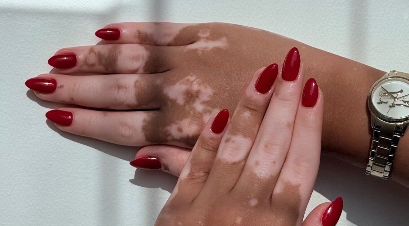 Red manicured hands at Fatima Beauty House, Aqaba, Aqaba Governorate, JO, showcasing elegant nail art.