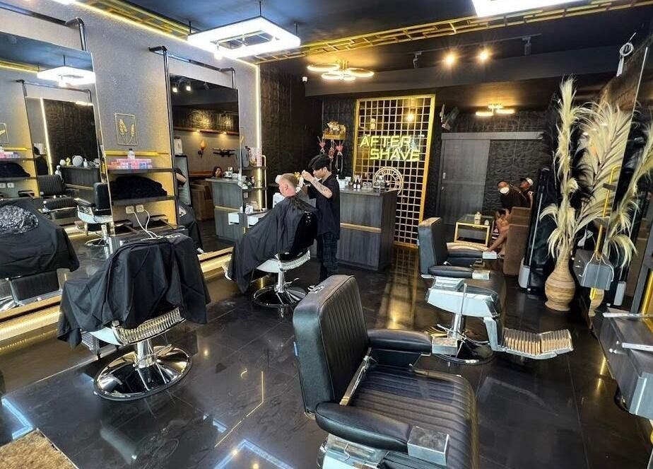Interior of AFTERSHAVE BARBERSHOP in Bali, Bali, ID, featuring modern decor and a stylist at work.