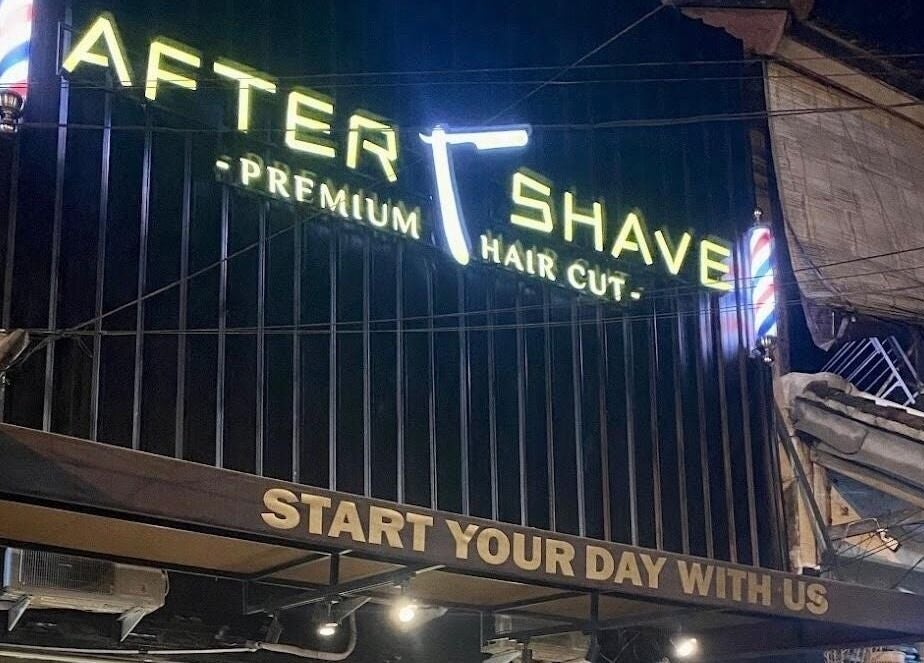 Illuminated sign of AFTERSHAVE BARBERSHOP in Bali, Bali, ID showcasing premium haircuts.