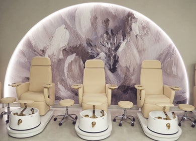 Elegant pedicure chairs at Crowns & Petals Beauty Salon, Dubai, AE, showcasing a serene ambiance with modern decor.