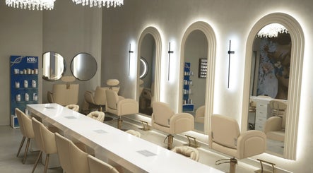 Luxurious interior of Crowns & Petals Beauty Salon in Dubai, AE showcasing bright mirrors and chic seating.