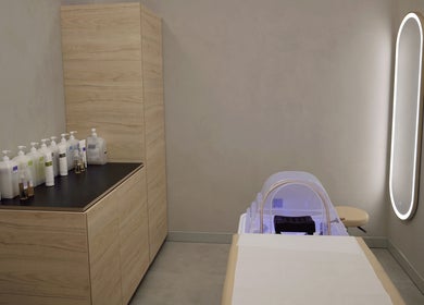 Elegant spa room at Crowns & Petals Beauty Salon, Dubai, AE, featuring modern equipment and soothing lighting.
