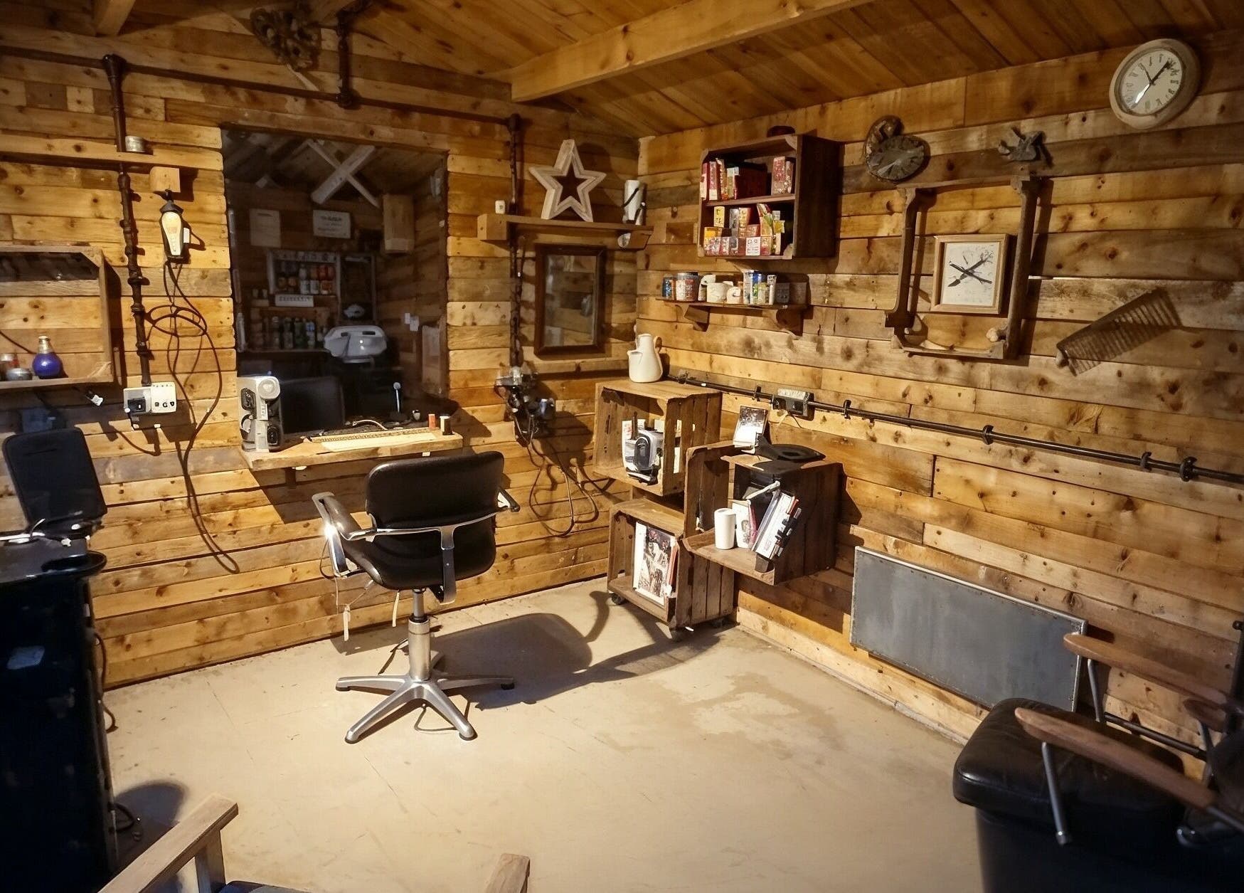 Cozy rustic interior of The Cabin in Codicote, England, GB, showcasing a warm wood-paneled beauty salon.