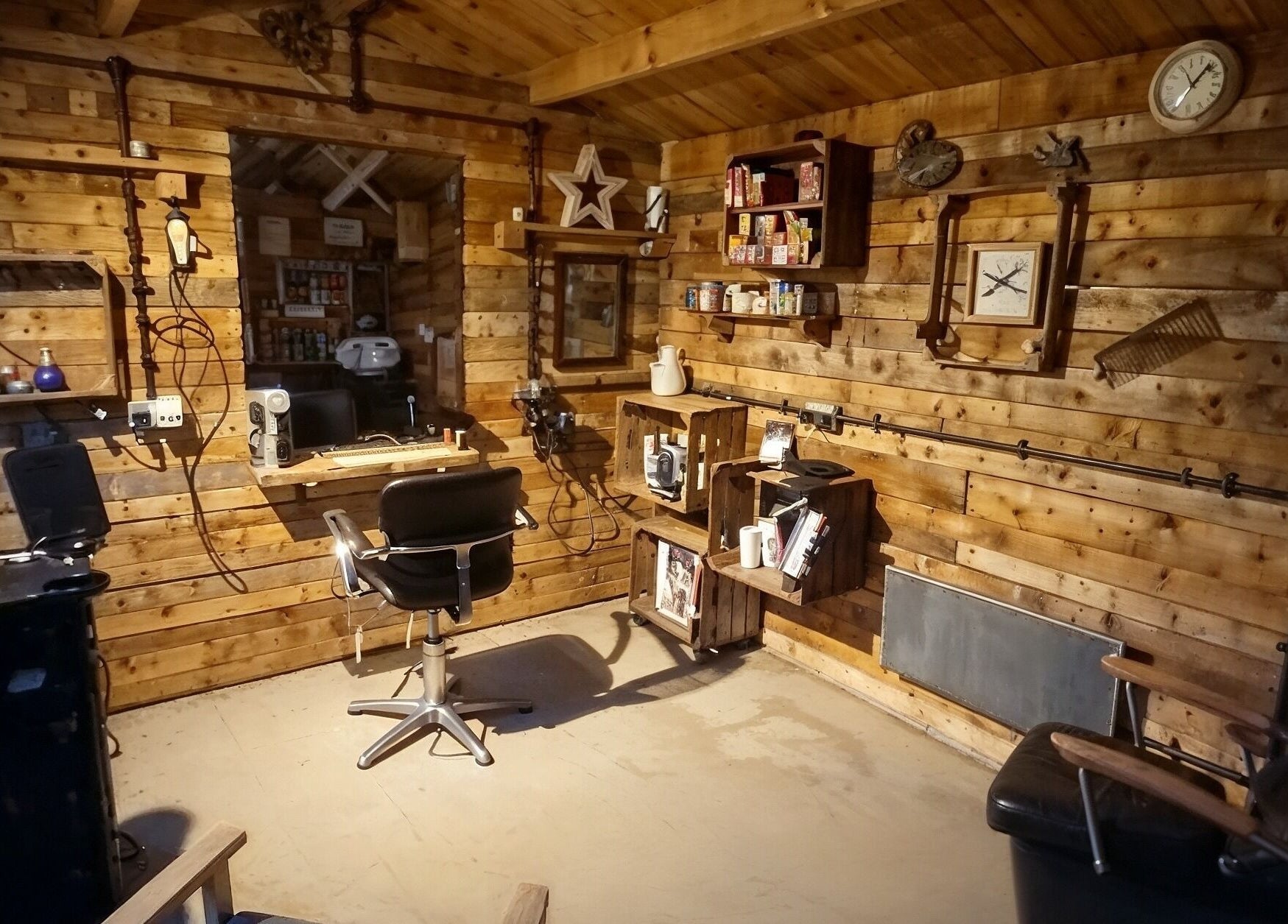 Cozy rustic interior of The Cabin in Codicote, England, GB, showcasing a warm wood-paneled beauty salon.