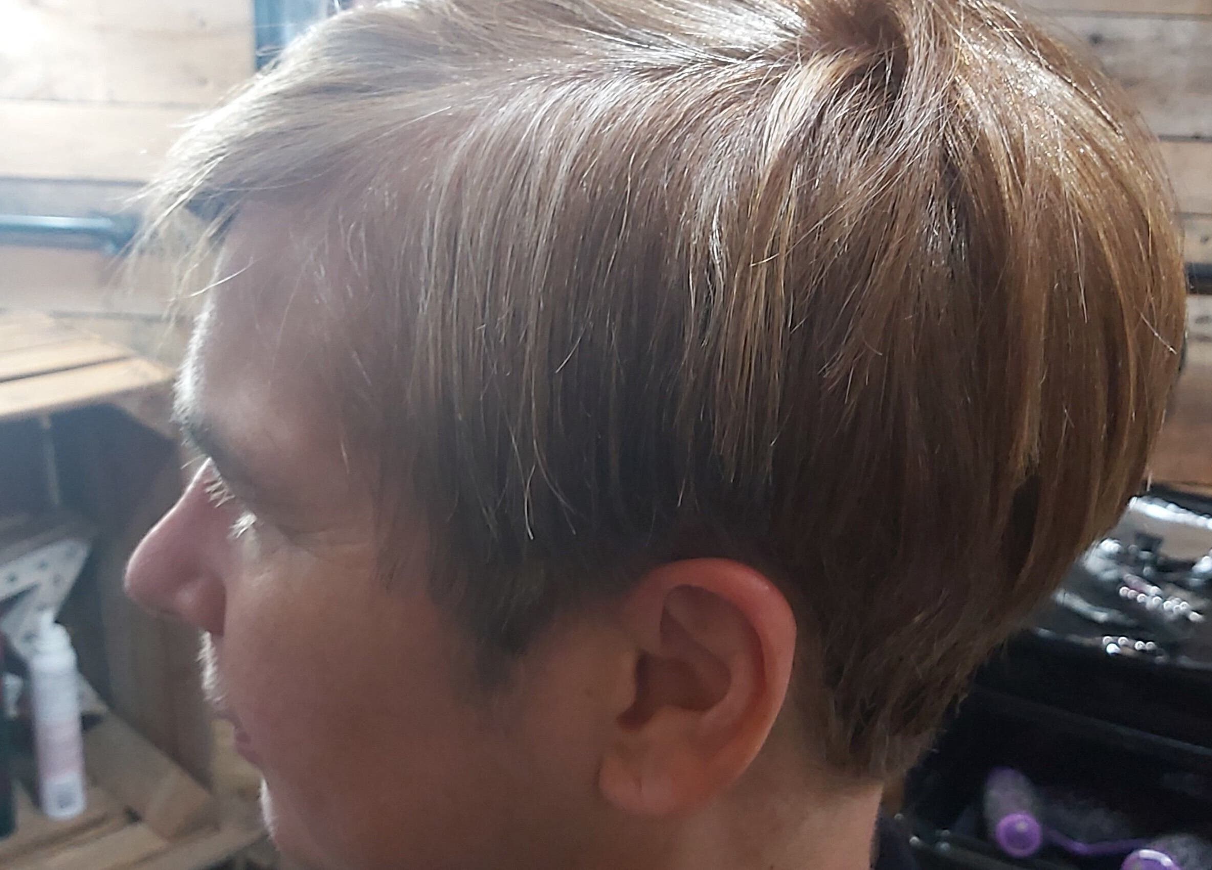 Side view of a stylish haircut at The Cabin, Codicote, England, GB showcasing glossy, well-groomed hair.