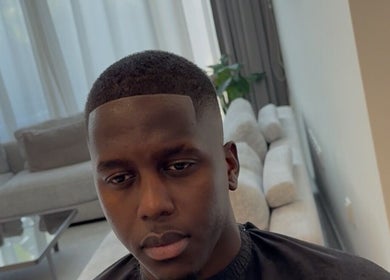 Modern haircut at Klipkonnect, Dubai, Dubai, AE featuring a sleek fade style.