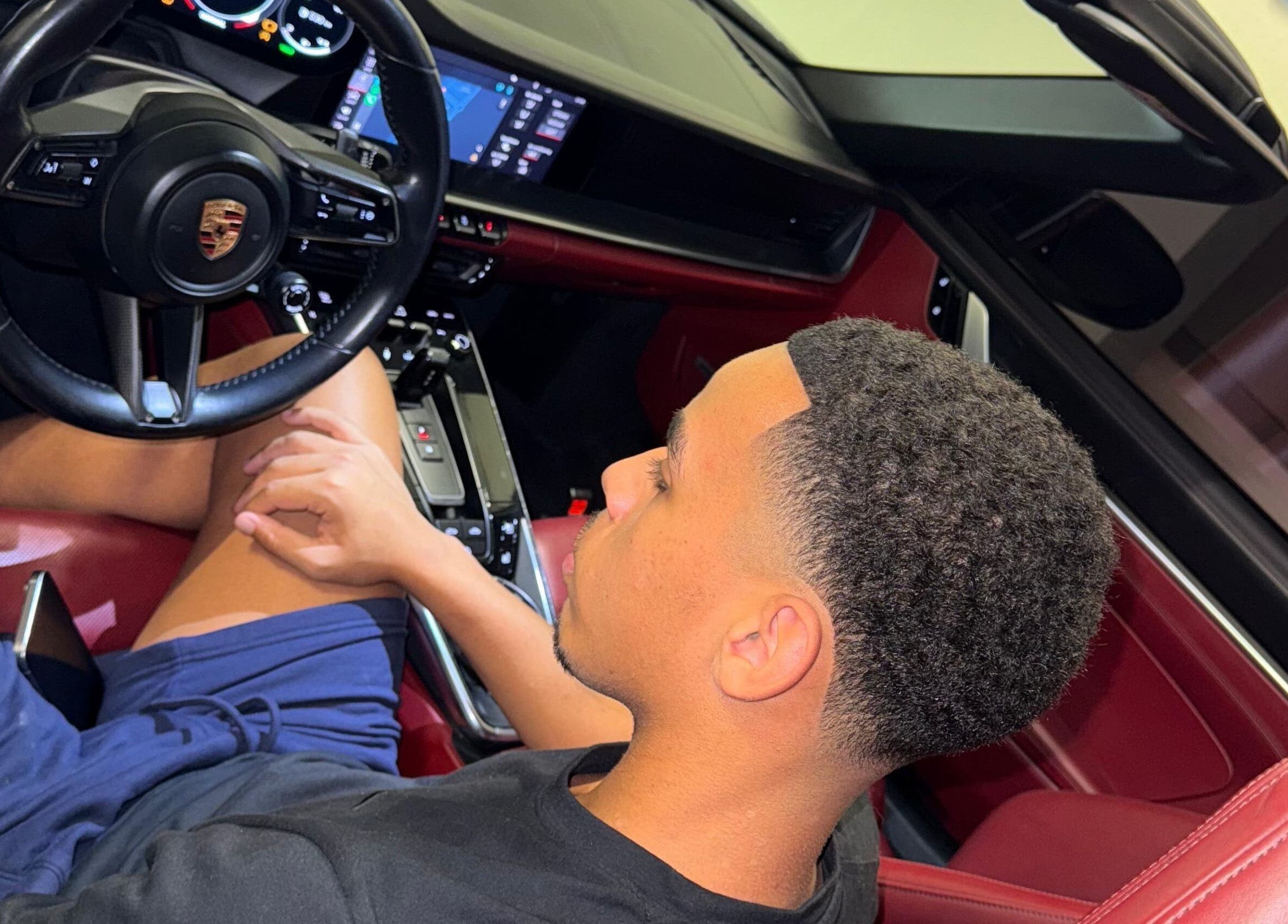 Man sitting in luxury car showcasing style at Klipkonnect, Dubai, Dubai, AE.