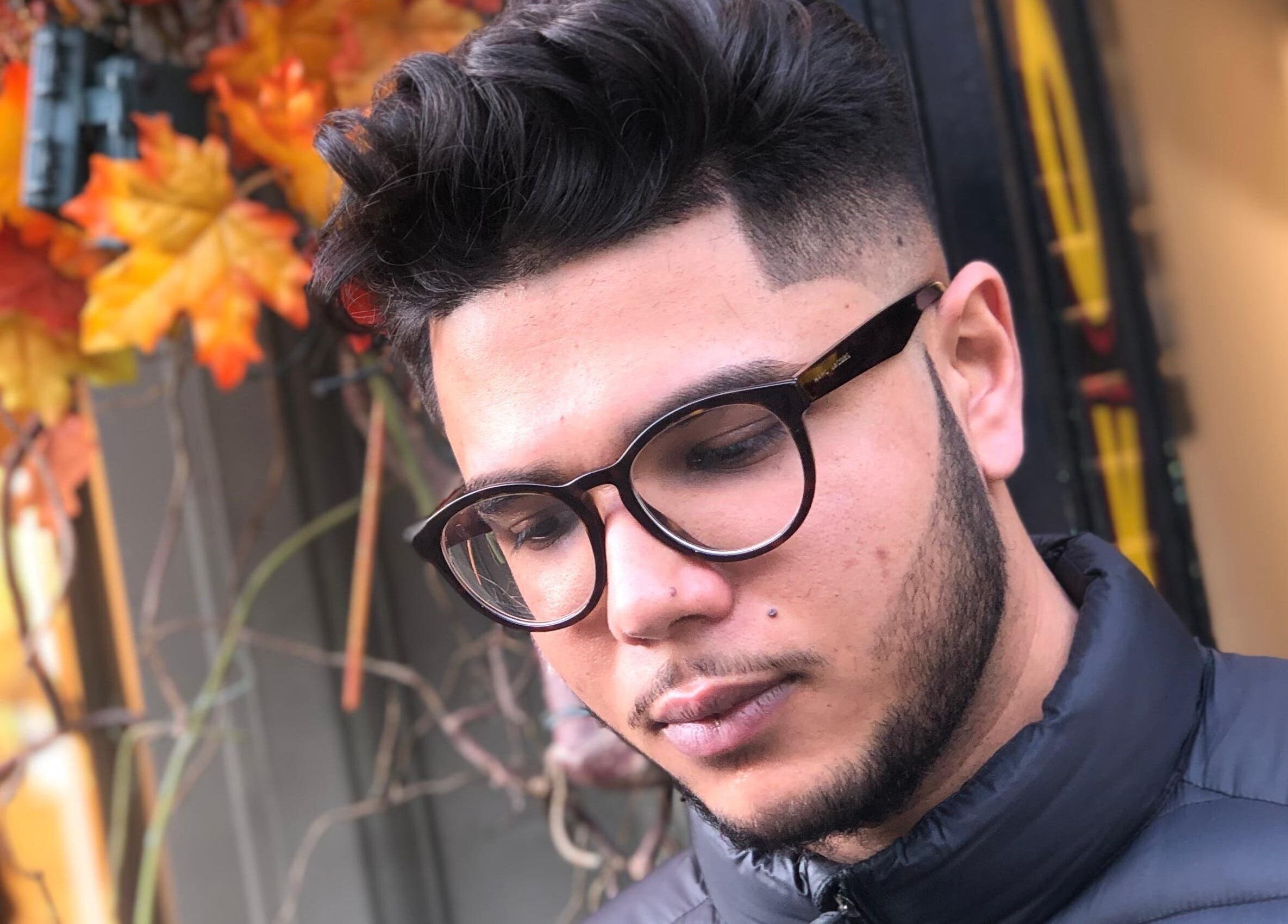 Man with trendy haircut and glasses at Klipkonnect, Dubai, Dubai, AE, showcasing fall fashion.