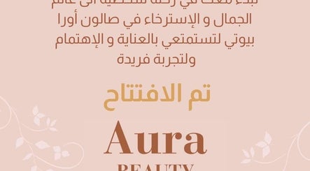 Grand opening announcement for Aura Beauty in المبرز, المنطقة الشرقية, SA, featuring elegant floral design.