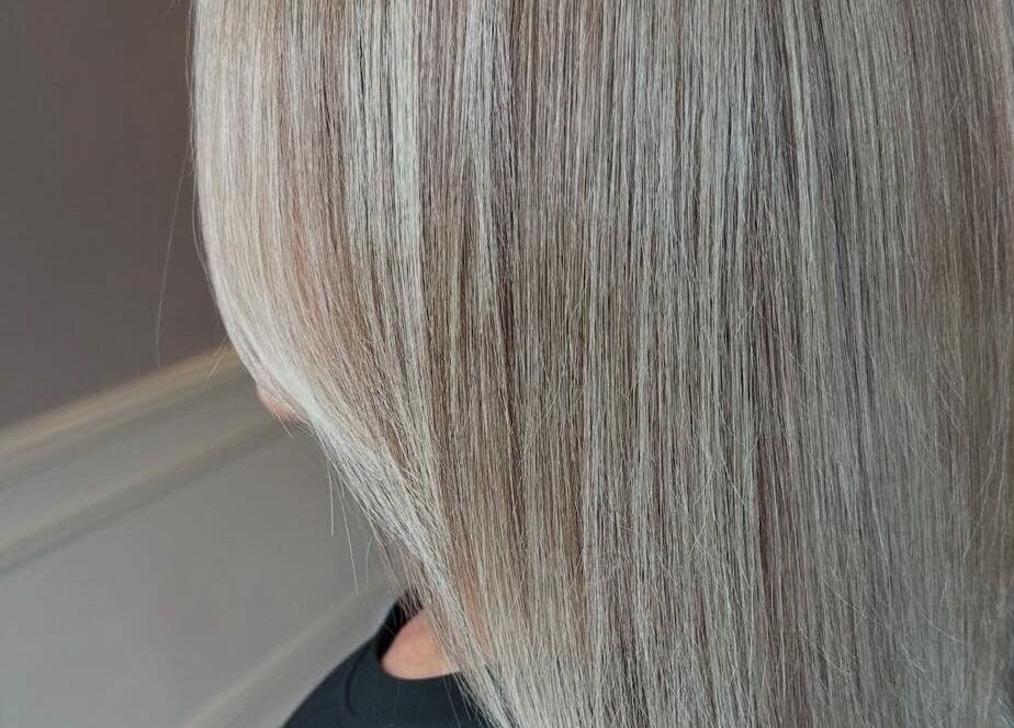 Sleek blonde hairstyle by Mob Hair Mobile Appointments in Giltbrook, England, GB. Perfect for a elegant makeover.