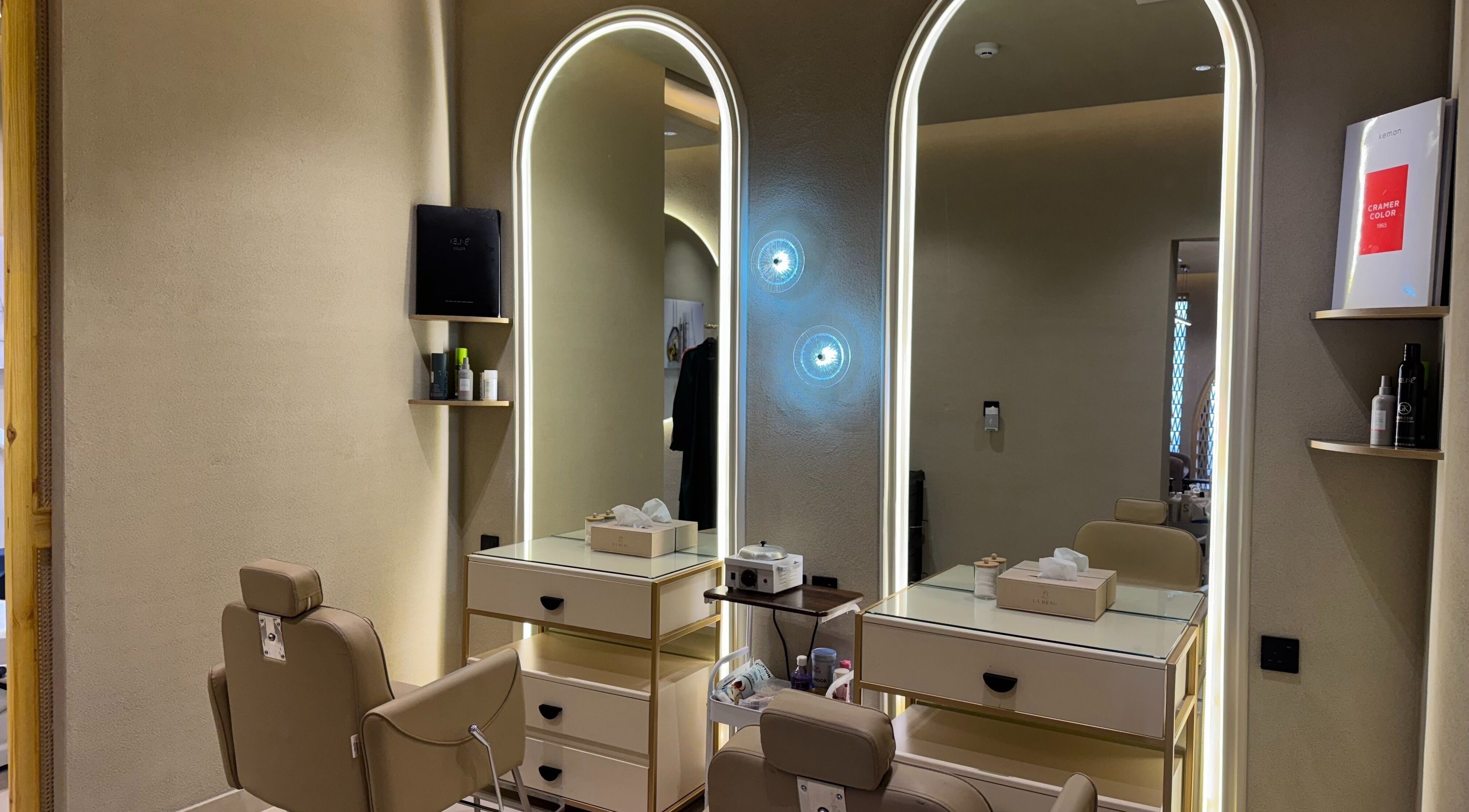 Sophisticated styling station at La Beau Salon, الرياض, منطقة الرياض, SA, featuring elegant chairs and mirrors.