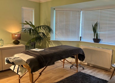 Serenity Therapy - Massage & Wellbeing in Bournemouth offers a peaceful, softly-lit massage room for relaxation.