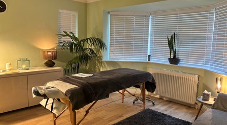 Serenity Therapy - Massage & Wellbeing in Bournemouth offers a peaceful, softly-lit massage room for relaxation.