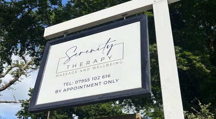 Serenity Therapy - Massage & Wellbeing entrance sign in Bournemouth, England, GB, amidst lush trees.