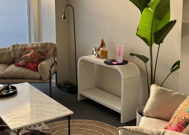 Chic lounge area at Divine Aesthetics in Levin, Manawatū-whanganui Region, NZ, featuring cozy sofas and vibrant decor.