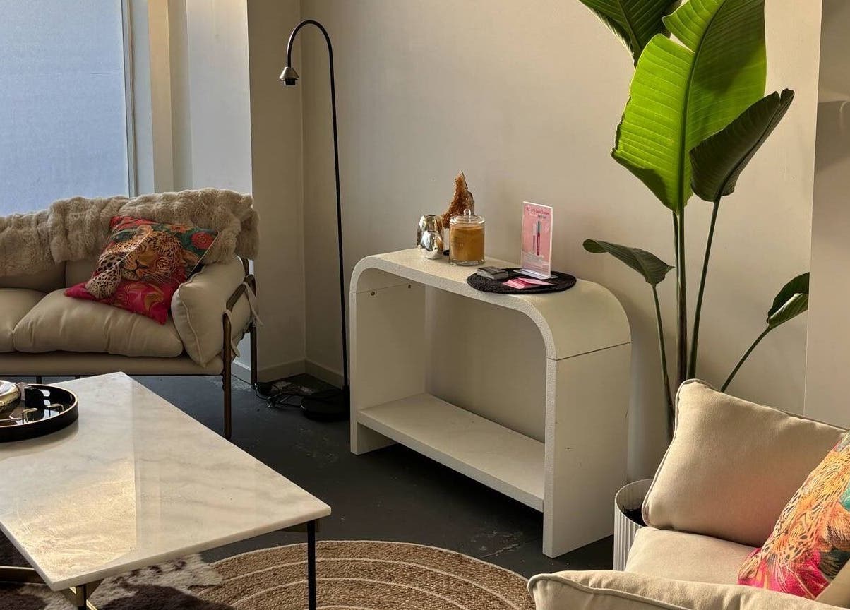 Chic lounge area at Divine Aesthetics in Levin, Manawatū-whanganui Region, NZ, featuring cozy sofas and vibrant decor.