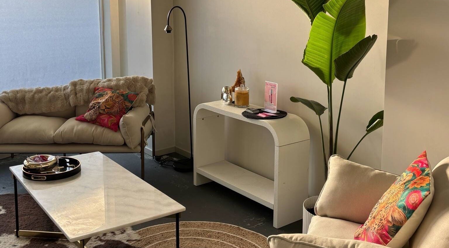 Chic lounge area at Divine Aesthetics in Levin, Manawatū-whanganui Region, NZ, featuring cozy sofas and vibrant decor.