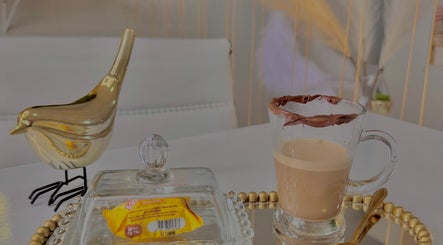 Café elegante no Nicole Charão Beauty & Clinic, Rio Grande Do Sul, BR, ao lado de decoração dourada.