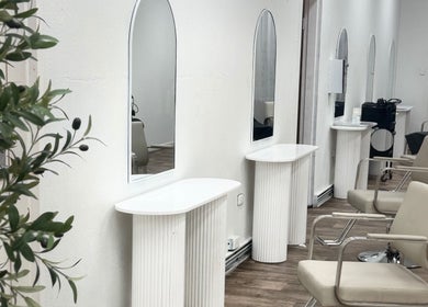 Elegant salon interior at Temple by Zyna, Moranbah, Queensland, AU showcasing modern styling stations.
