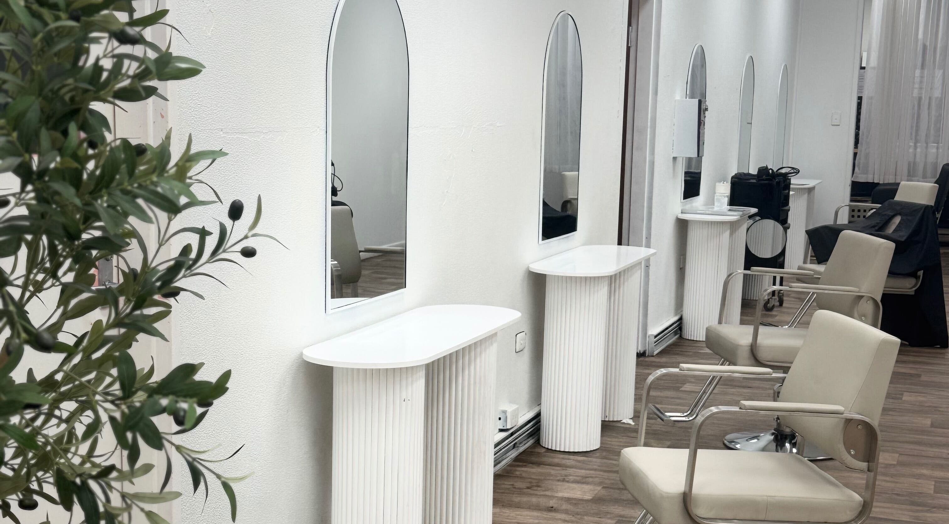 Elegant salon interior at Temple by Zyna, Moranbah, Queensland, AU showcasing modern styling stations.