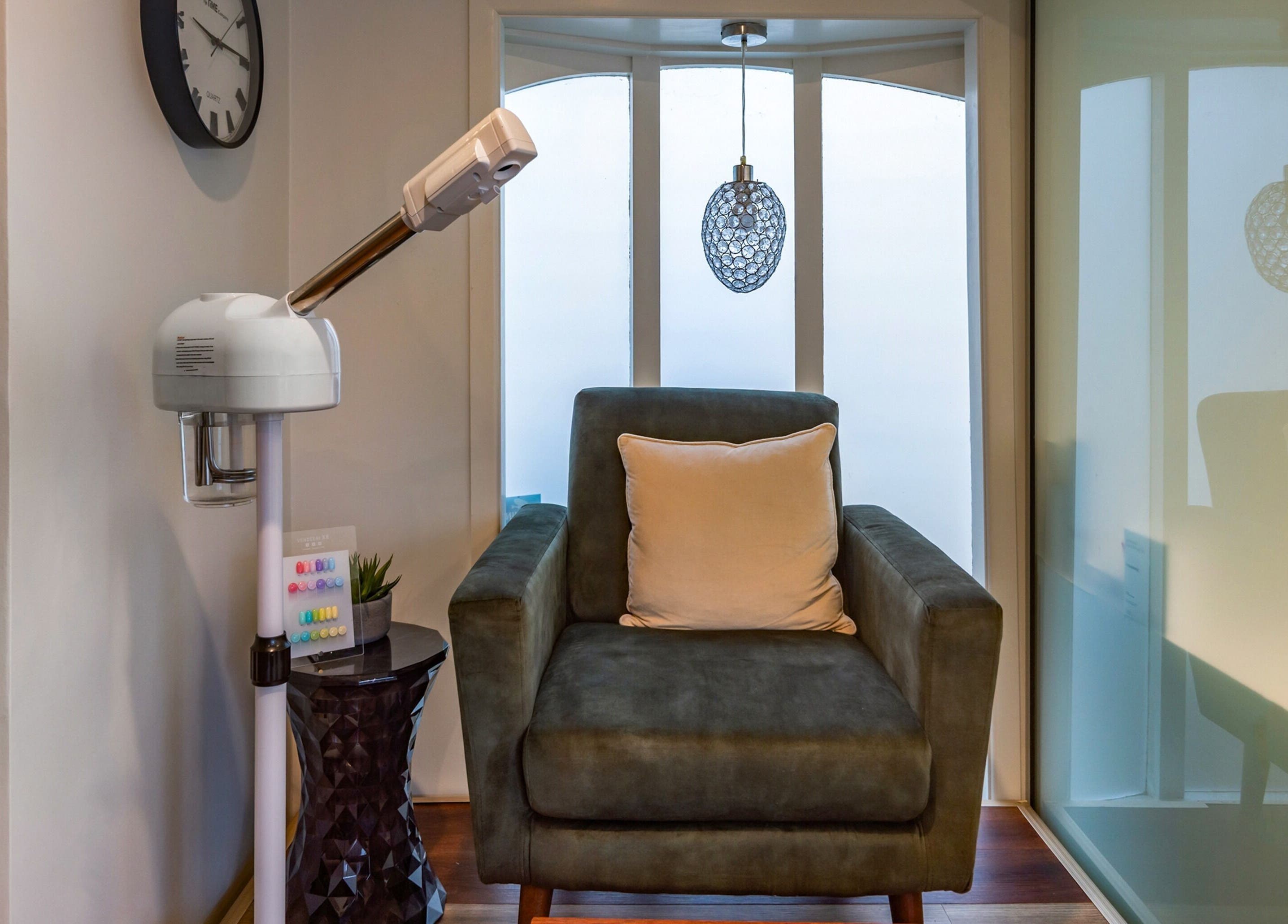 Relaxing armchair in Verdo Beauty Parnell, Auckland, NZ featuring modern lamp and decor.