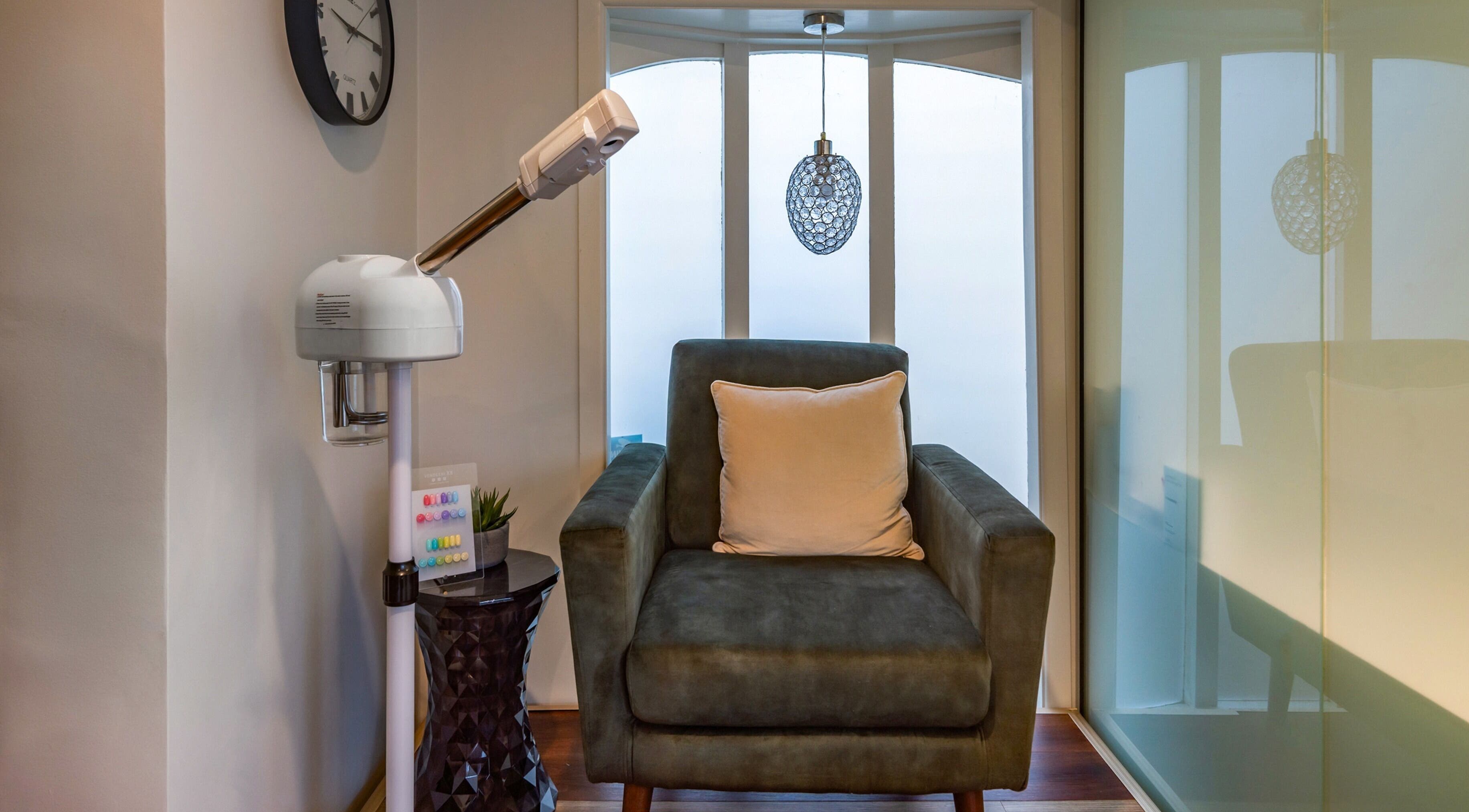 Relaxing armchair in Verdo Beauty Parnell, Auckland, NZ featuring modern lamp and decor.