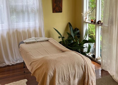 Peaceful massage room at Humm Massage, Sawtell/Coffs Harbour, New South Wales, AU, with soft lighting and plants.