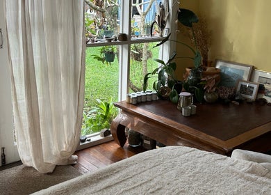Calming room at Humm Massage, Sawtell/Coffs Harbour, New South Wales, AU with natural light and cozy decor.