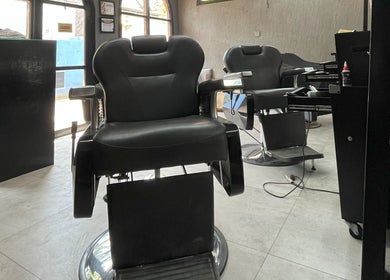 Sleek barber chairs at Barbershop AK-15, Nusa Tenggara Barat, ID, offering top-notch grooming services.