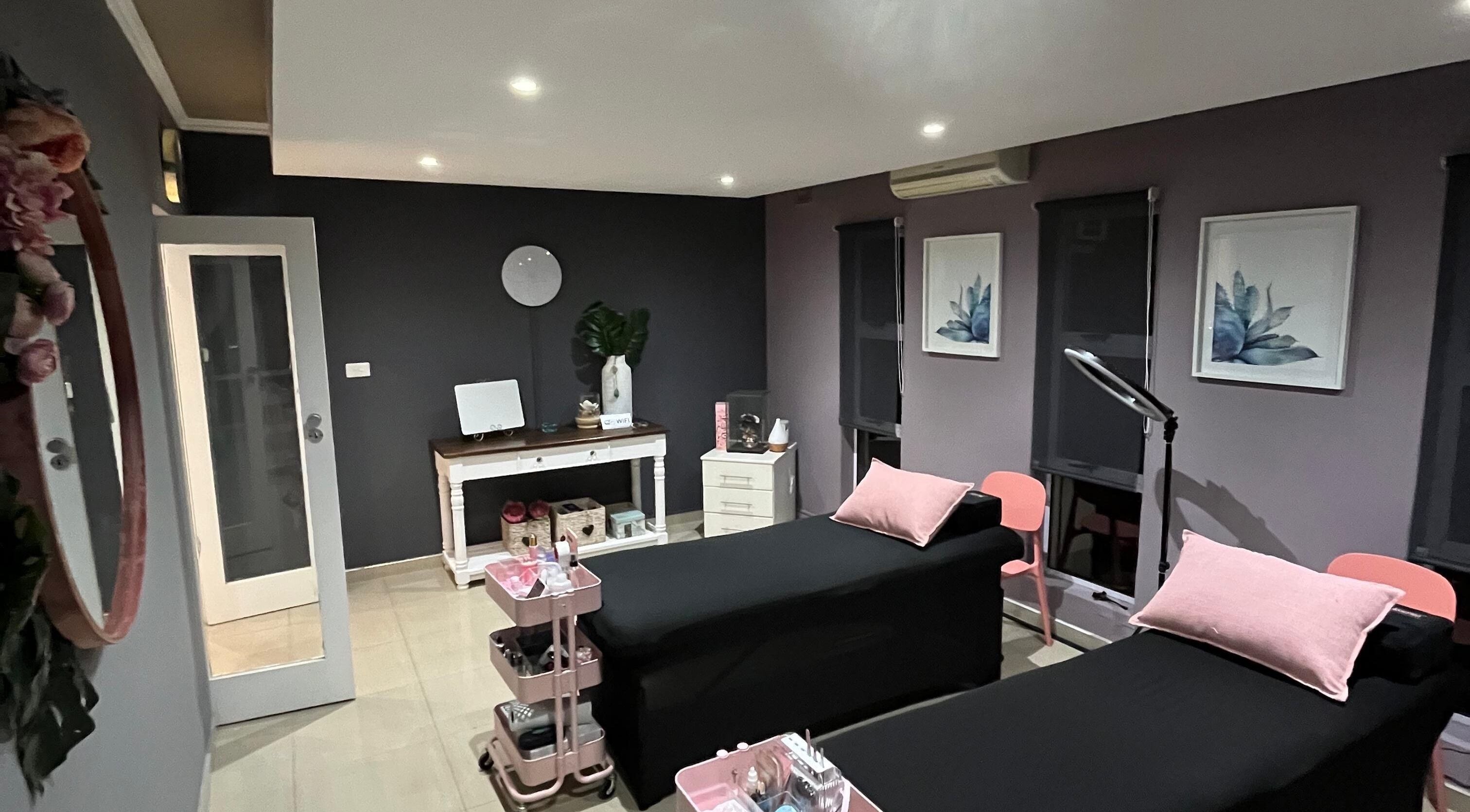 Relaxing treatment room at Jackie Bee Aesthetics, Ballito, Kwazulu-natal, ZA with elegant decor and cozy beds.