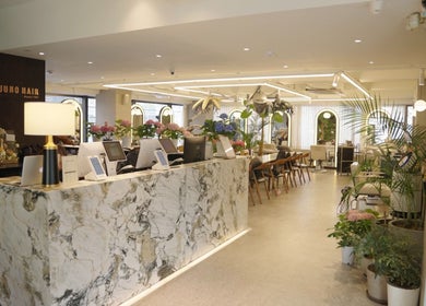 Chic interior of Juno Hair Apgujeong Rodeo branch in Seoul, South Korea, showcasing modern decor and warm ambiance.