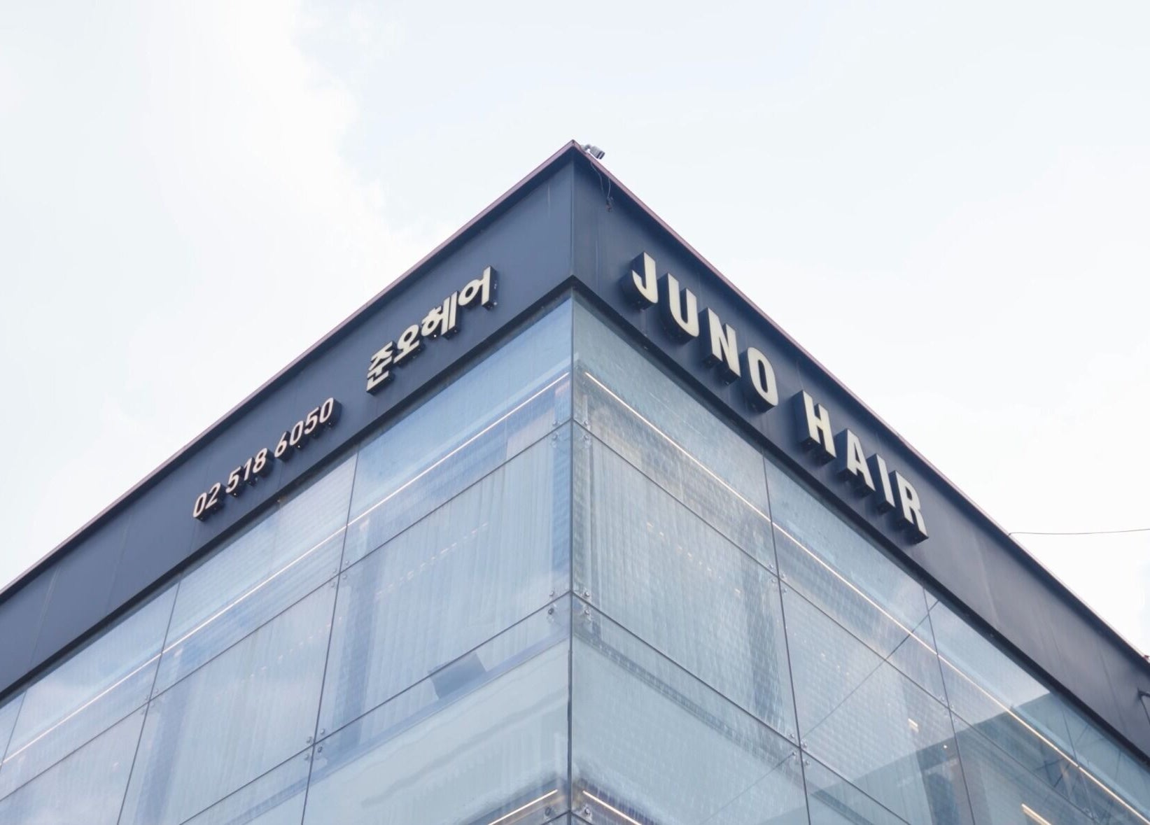 Exterior of 준오헤어 압구정로데오１호점, Seoul, showcasing modern architecture and signage.