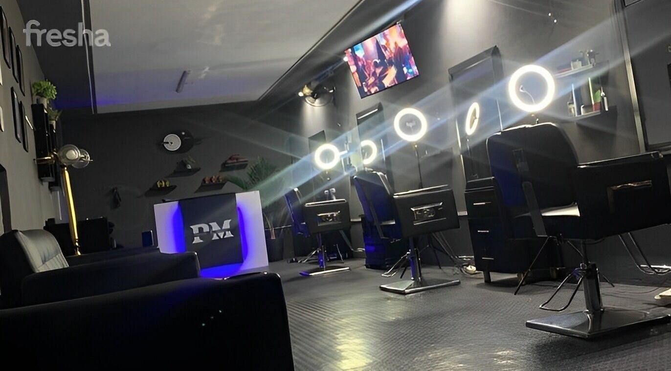 Chic interior of Pimville Menkave in Pimville, Gauteng, ZA with sleek barber chairs and glowing mirrors.