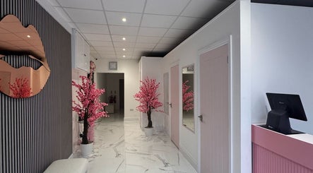 Modern, elegant interior at Sevens, Cardiff, Wales, GB. Features pink blossoms and a unique lip-shaped mirror.