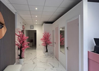 Chic interior of Sevens with pink cherry blossoms, Cardiff, Wales, GB. Elegant and inviting wellness space.