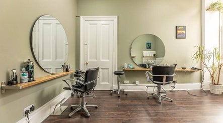 Chic interior of Scott’s Hairdressing in Glasgow, Scotland, GB featuring modern styling chairs and mirrors.