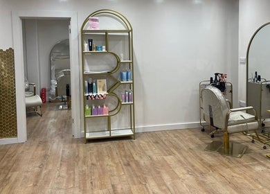 Stylish salon setup at Hijabi Hair, Bristol, England, GB with chic chairs, mirrors, and a product display.