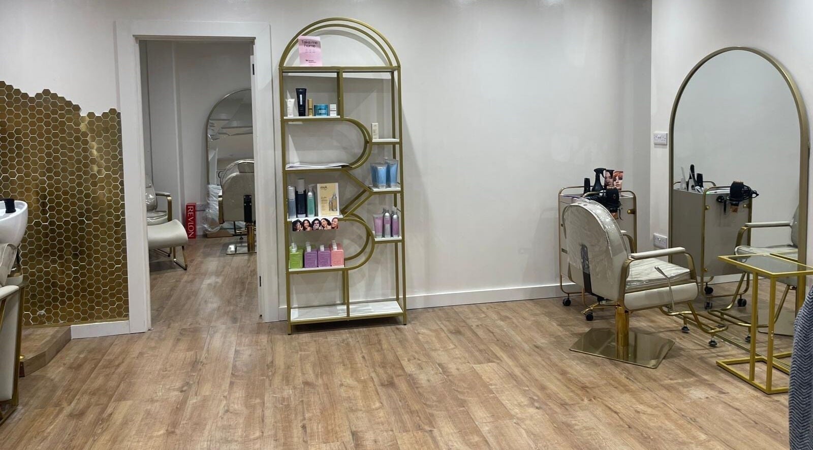 Stylish salon setup at Hijabi Hair, Bristol, England, GB with chic chairs, mirrors, and a product display.