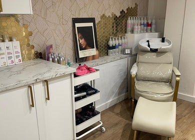 Hair care station at Hijabi Hair, Bristol, England, GB, featuring a stylish salon chair and products.