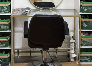 Stylish salon station at Dexters Lab in London, England, GB with modern black chair and organized storage bins.