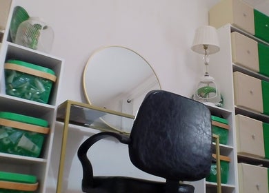 Elegant beauty station at Dexters Lab in London, England, GB featuring a mirror, chair, and organizers.