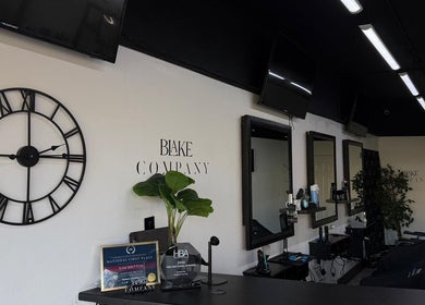 Blake Company salon interior with stylish decor in Kenilworth, England, GB, featuring elegant mirrors and chairs.