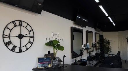 Blake Company salon interior with stylish decor in Kenilworth, England, GB, featuring elegant mirrors and chairs.