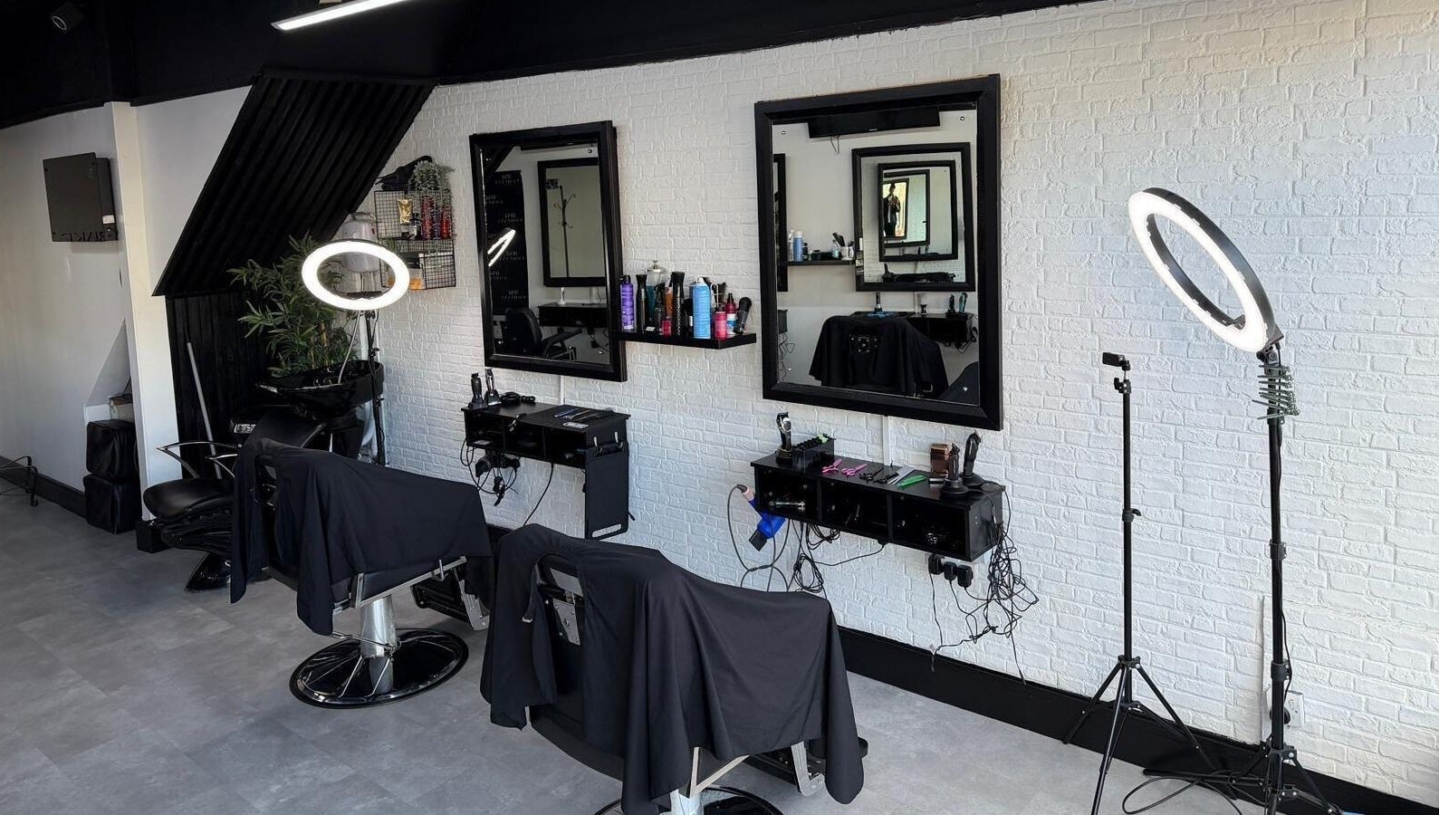 Modern salon interior at Blake Company, Kenilworth, England, GB with chic styling stations and professional lighting.