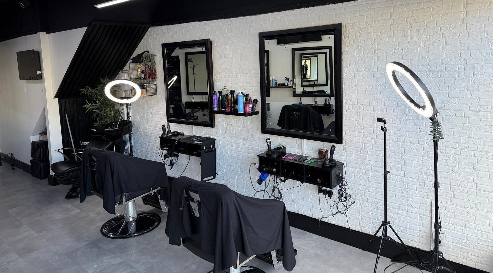 Modern salon interior at Blake Company, Kenilworth, England, GB with chic styling stations and professional lighting.