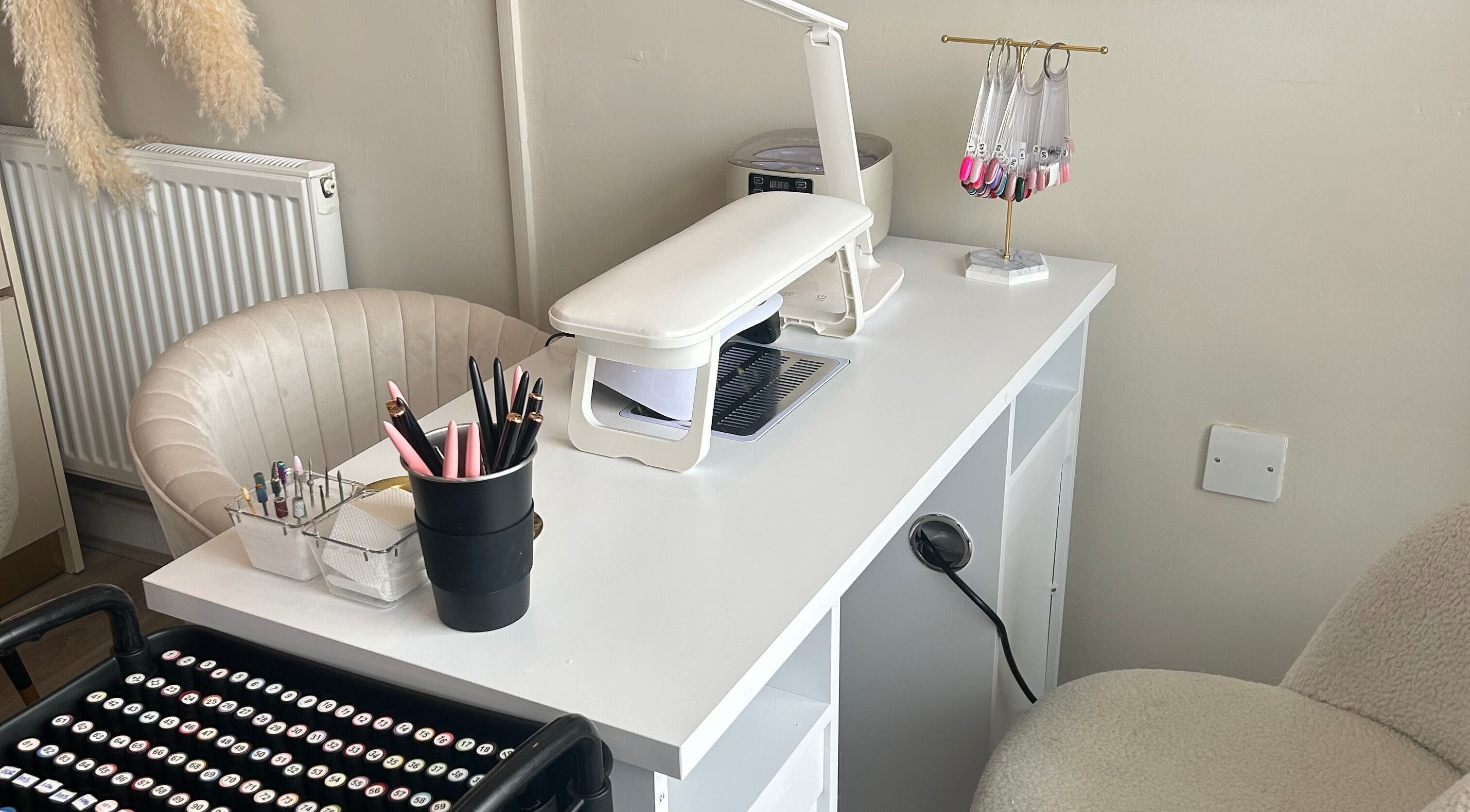 Stylish nail station at Nails by Norrie, Caernarfon, Cymru, GB showcasing tools and polish options.