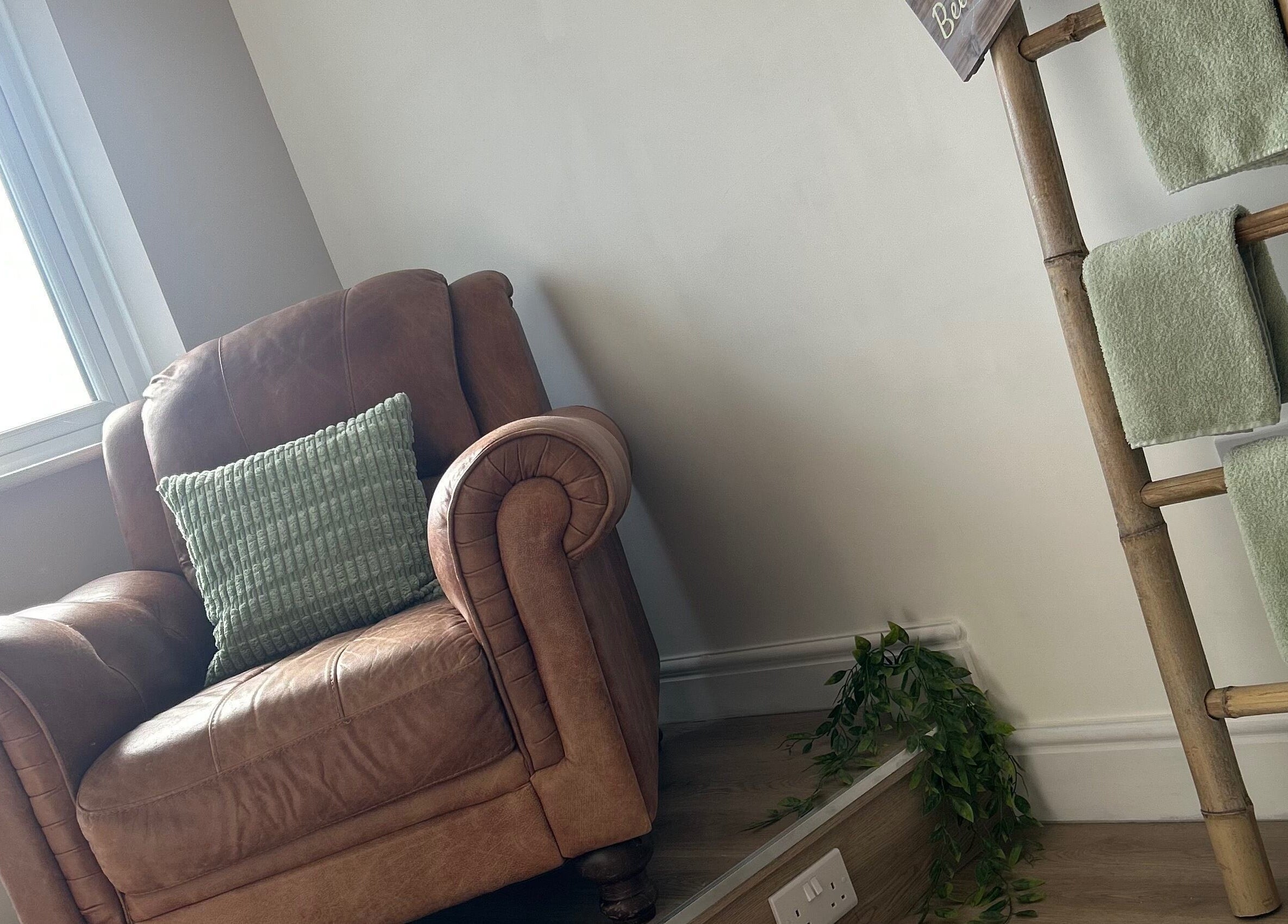 Cozy brown leather chair and bamboo towel rack at Sophie’s Ultimate Beauty, Deeping Saint James, England, GB.